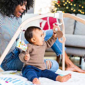 a child unpacking the colorful wrapped gift