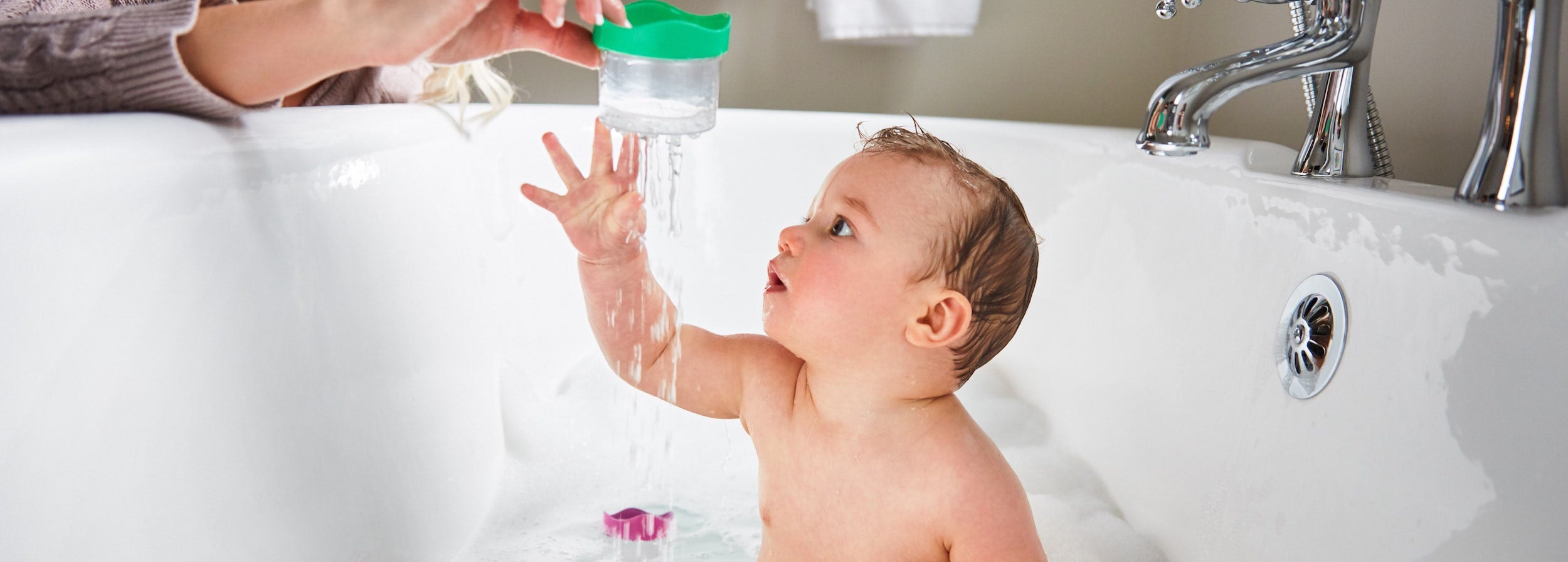 baby playing in a tub